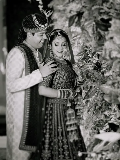 A timeless black and white portrait of the couple on their wedding day. This style emphasizes the emotion and connection between them, creating a classic piece of art.