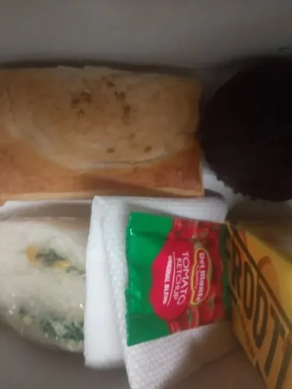 This snack box contains a vegetable puff, a sandwich, a chocolate muffin, and a fruit juice pack. It's a great example of how we can mix and match items to create a balanced and convenient snack for any occasion.