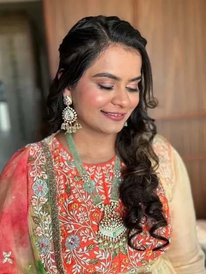 A beautiful soft glam look for a client in a colorful outfit. The makeup is warm and glowing.