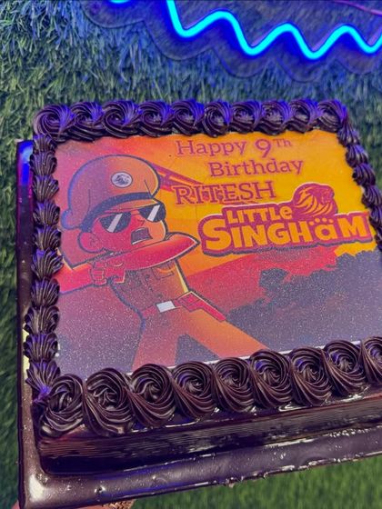 A Little Singham photo cake for a 9th birthday. This chocolate cake features an action-packed edible image of the brave police officer, perfect for young fans of the show.