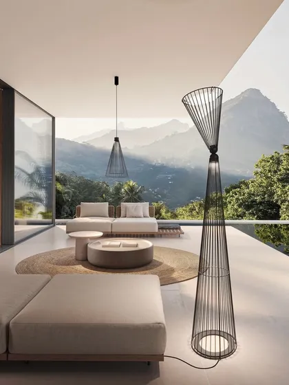 My work extends beyond the four walls of a home. This sculptural floor lamp from the Ikonika collection by Karman is designed for both indoor and outdoor use. Its airy metal cage creates a visual dialogue with the natural environment, providing soft, diffused light for a terrace with a view.