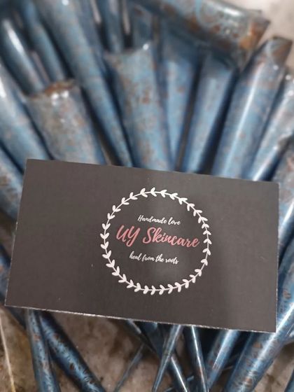 A pile of my handmade henna cones with my business card. Both nail cones and regular henna cones are available for creating beautiful designs.