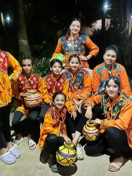 Posing with their props, our folk dance team is ready to light up the stage. One student shows incredible balance, a skill we develop through a mix of dance and fitness training.