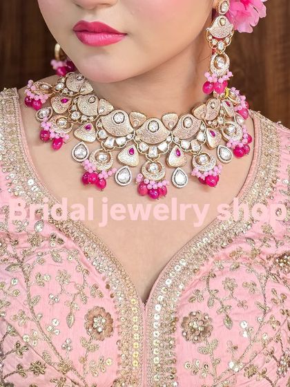 A close-up of the pink meena Polki necklace, showing the intricate work and vibrant color.