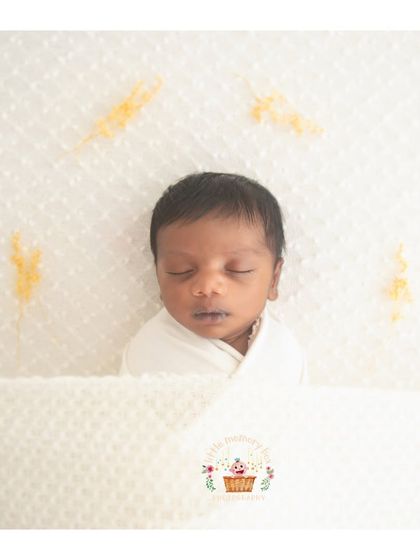 A close-up version of the minimalist white swaddle, focusing on the baby's serene expression. These images are timeless and will never go out of style.