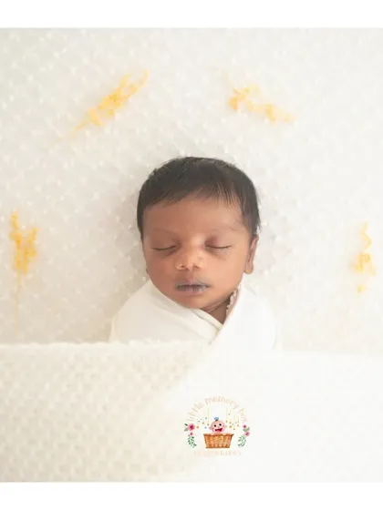 A close-up version of the minimalist white swaddle, focusing on the baby's serene expression. These images are timeless and will never go out of style.