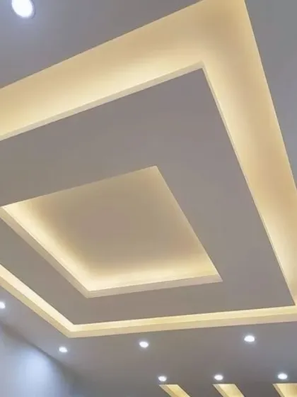 This is a classic tray ceiling design. The recessed center and hidden lighting provide a soft, ambient glow, making the room feel spacious and airy.