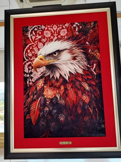 A majestic eagle rendered in the unique style of carpet painting by Fannan Raaz. The intense gaze and detailed feather work are a testament to his skill.