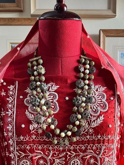 A close-up of the neckline, styled with a statement necklace to show its festive potential.