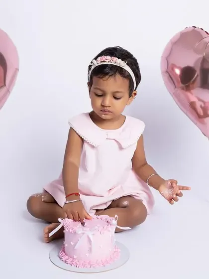 The first touch of the cake is always a moment of curiosity. This little princess is contemplating her next move during her second birthday photoshoot.