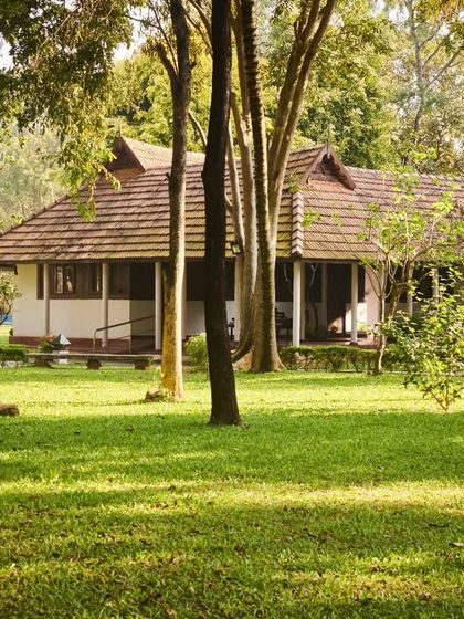 Our heritage accommodations are nestled within a sprawling green landscape. This view showcases how each restored building coexists harmoniously with nature, creating a true healing village.
