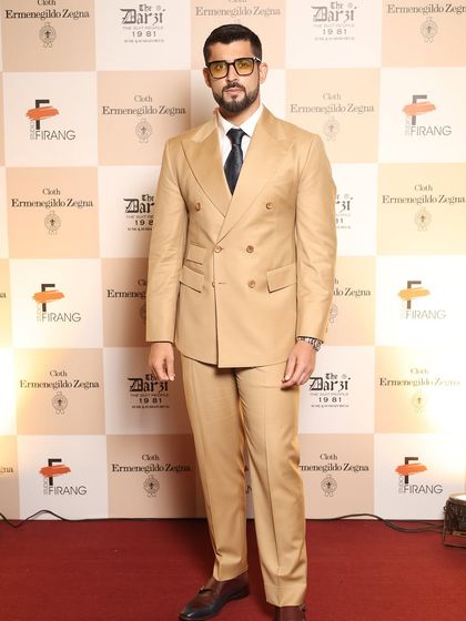 The epitome of red-carpet style. This guest's confident stance in his bespoke Zegna suit showcases the flawless fit and powerful silhouette we achieve for our clients.