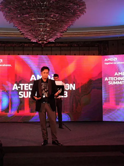 On stage at the AMD A-Technovation Summit 2023. The curved LED screen provided a stunning backdrop for my mentalism session.