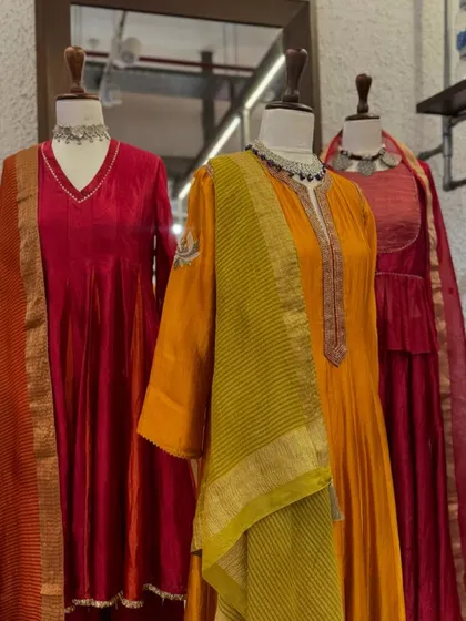 A warm and inviting display of red and orange anarkalis. The crushed fabrics and delicate gold borders are perfect for the festive season.