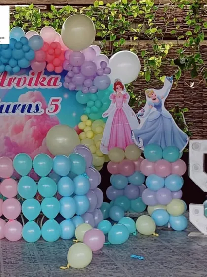 A magical Disney Princess theme for Arvika's 5th birthday. The backdrop featured a rainbow sky, beloved princesses, and a large light-up number '5', all surrounded by pastel balloons.