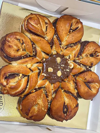 A top-down view of the Nutella Hazelnut Snowflake bread, showing the delicious filling and toasted nuts in the center.