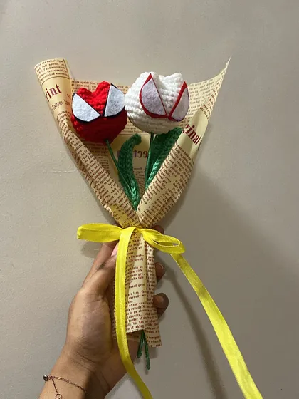 A closer look at this custom Spider-Man themed order. The red and white crochet tulips are designed to look like the superhero's mask, making it a perfect gift for a fan.