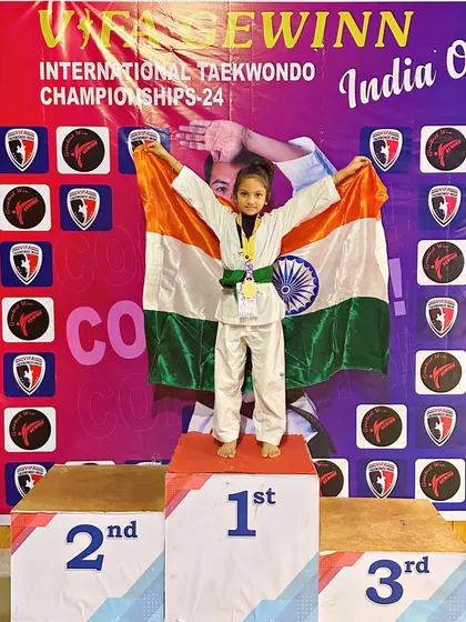 A moment of pure pride as one of our young champions stands on the first-place podium at an international Taekwondo championship. This is what hard work, courage, and the spirit of a champion looks like.