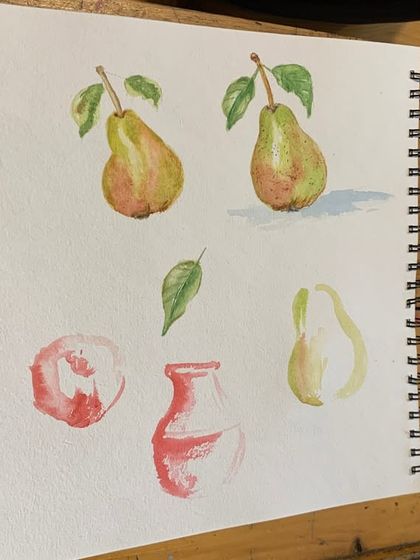 A student's sketchbook filled with watercolor studies of pears and other fruits. This practice is key to understanding form, light, and color in still life painting.