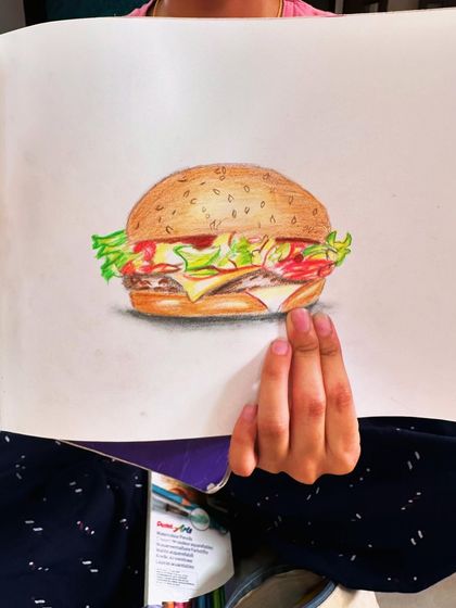 A delicious-looking burger drawn with color pencils. It's so much fun to draw your favorite foods.
