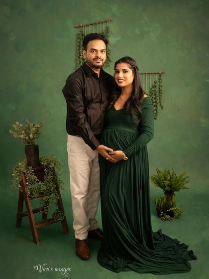 A lovely portrait of the couple surrounded by greenery. Their gentle embrace and happy smiles create a warm and natural image.