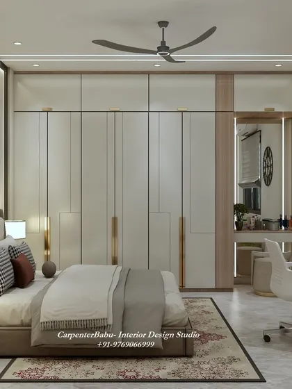 This view shows the full-wall wardrobe with its elegant gold-accented handles, which add a touch of luxury to the minimalist design.