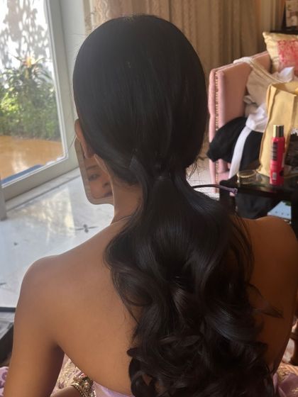 A behind-the-scenes shot of a simple, elegant ponytail with soft waves that I created. This was the base before adding more intricate accessories.