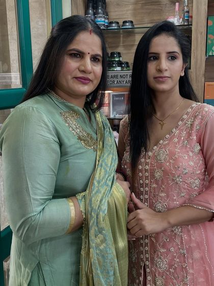 A mother-daughter duo getting ready at our salon. We provided age-appropriate, elegant makeup for both of them for their special family function.