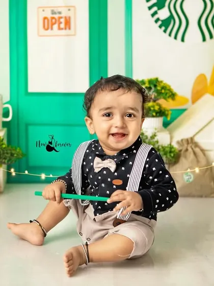 A happy smile from the best barista around. His adorable outfit with a bow tie and suspenders completes the look perfectly.