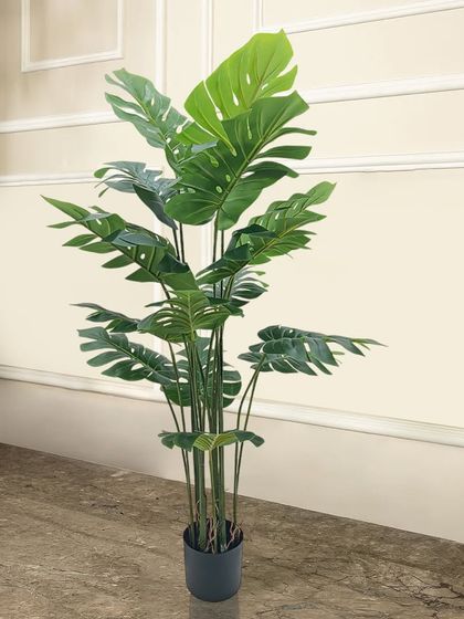 The artificial monstera plant, with its iconic split leaves, is a must-have for any modern or bohemian-style home. This large version is perfect for filling a corner with lush, maintenance-free greenery.