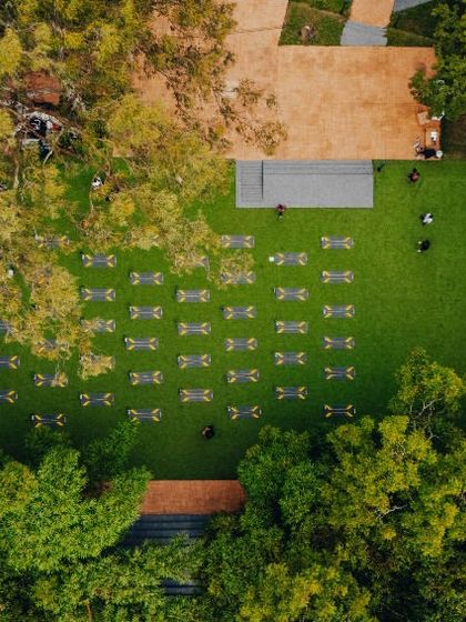 An aerial view of the 'Founders Peak' yoga retreat hosted here. My expansive lawn is perfect for large-scale wellness events.