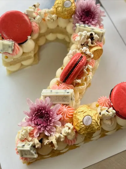 A detailed shot of the number '2' monogram cake, showcasing the textures and toppings.