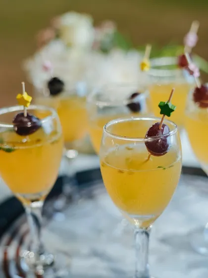 A light and fruity mocktail garnished with a cherry. Our beverage menu is diverse, with options to suit any theme or preference.