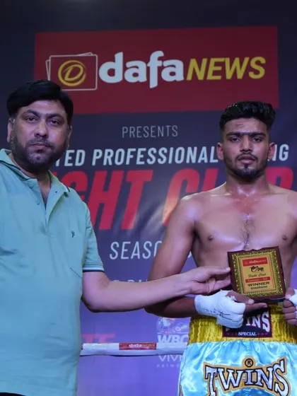 Presenting an award to a winning boxer at our Fight Club event. I am personally invested in the journey of every fighter.