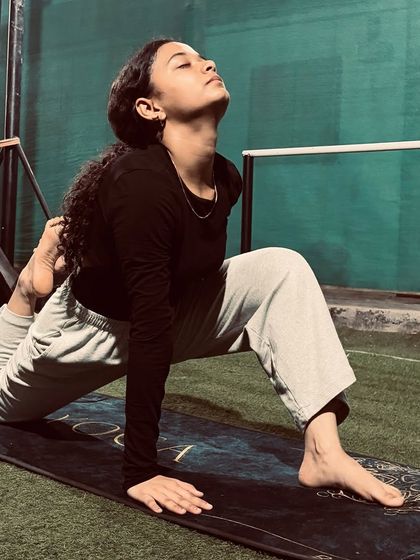 A moment of deep release in a low lunge with a quad stretch. This pose targets the hip flexors and quadriceps, crucial for athletes in any sport.