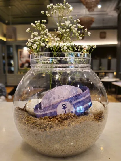Another version of the sailor-themed centerpiece, this time featuring a miniature sailor hat inside the glass bowl.