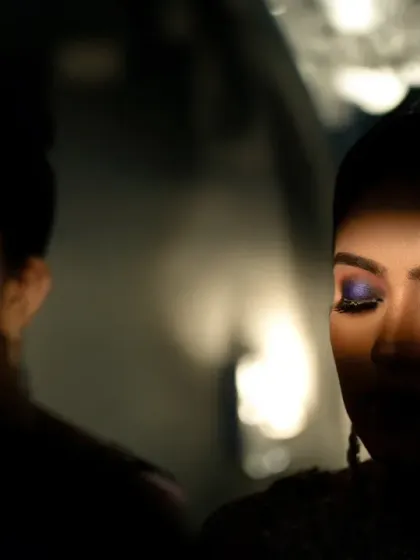 An artistic shot focusing on the bride's dramatic eye makeup, using reflections and shadows for a creative and moody effect.