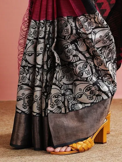 A close-up of the unique face print on the saree, a true conversation starter.