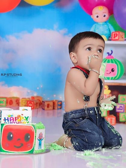 A messy and happy baby boy after his Cocomelon cake smash. These photos perfectly capture the fun and chaos of a first birthday.