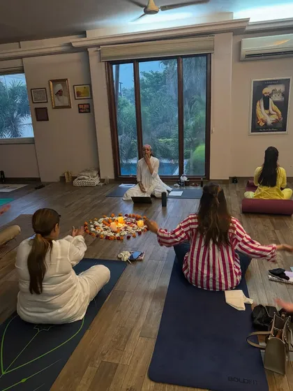 A sharing circle in session at my Pushpanjali Farms studio. The candlelit flower mandala at the center holds our collective intentions as we connect and share.