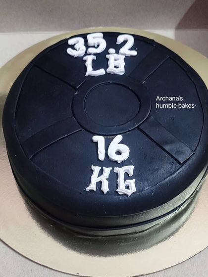 A cake designed to look like a gym weight plate, perfect for a fitness lover.