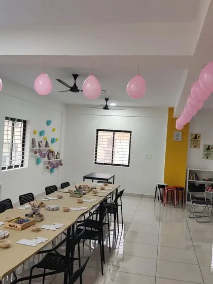Pink balloons add a festive touch to the studio space, all prepped for a creative birthday party. We ensure the environment is cheerful and inspiring.