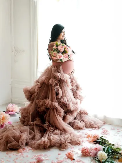 For the mama who wants to feel like a queen, our dramatic gown sessions are perfect. This portrait captures strength and beauty with a stunning ruffled gown and soft, natural light.