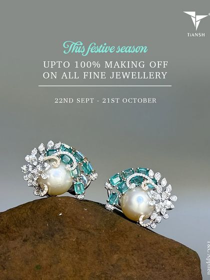 The season of sparkle is here. These beautiful earrings feature a central pearl surrounded by diamonds and light blue gemstones, resting on a natural stone.
