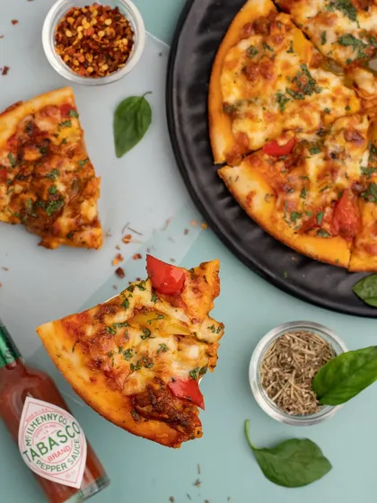 A flat-lay shot of a pizza we did for Snackiezz91. This top-down view shows all the toppings and is great for use on menus or in promotional flyers.