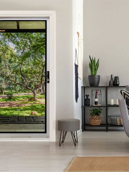 A TENTUFF hinged security door enhances this living space, allowing natural light and a view of the garden to become part of the room's decor. This is how we combine home security with interior design, ensuring your safe space is also a beautiful one.