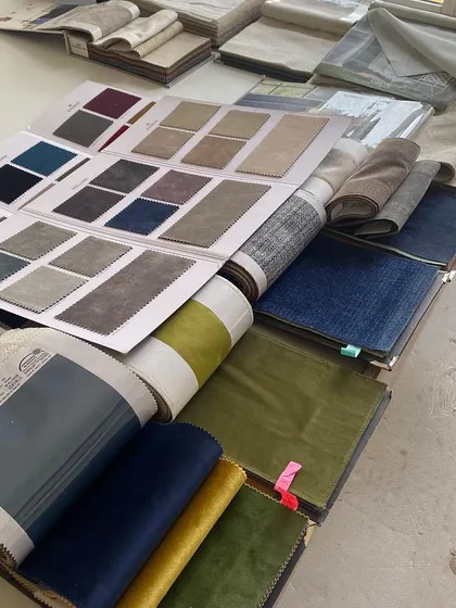 The fabric selection process for 'Vishu Home'. We laid out various swatches to visualize how different colors and textures would interact, ensuring a harmonious and sophisticated final look.