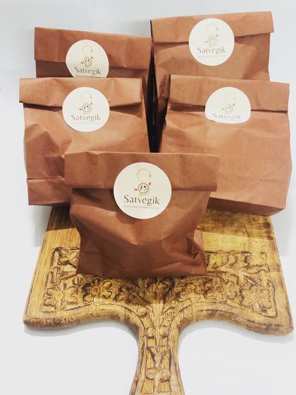 My products are always freshly packed for delivery. These brown paper bags with the Satvegik logo contain a variety of my healthy baked goods and snacks, ready to be sent out to customers.