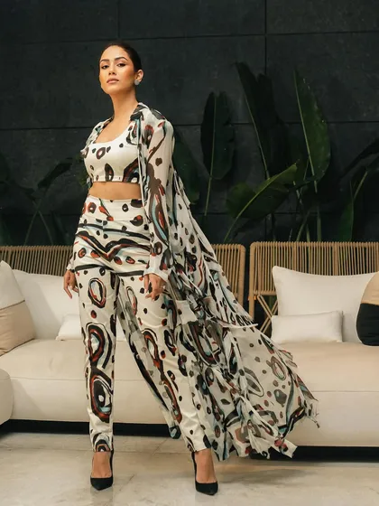 A powerful, centered pose from the same shoot, showcasing the full outfit with a confident and commanding presence.