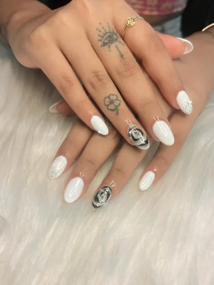 A chic and stylish set featuring white nails with silver glitter and black rose accent nails. The contrast between the black and white is very striking.